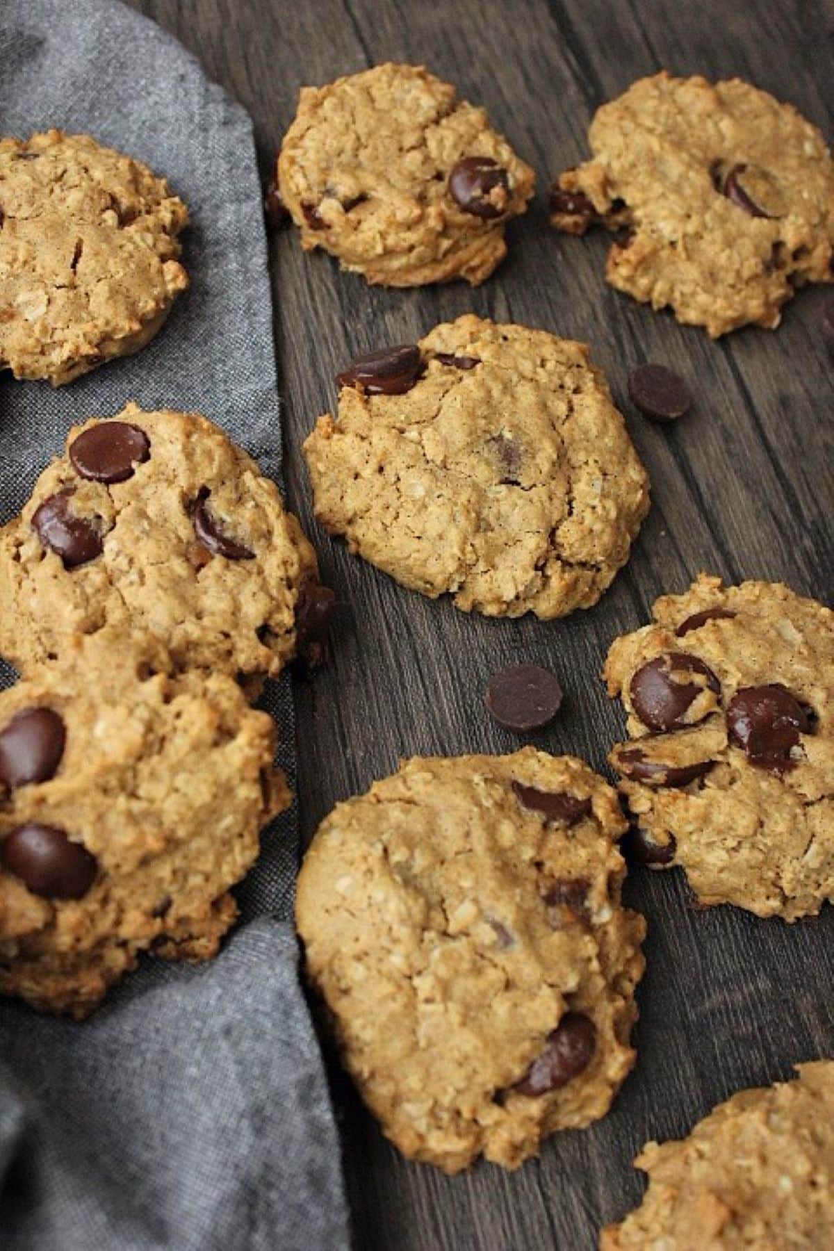 Image of gluten free oatmeal chocolate chip cookies on table with hand towel.