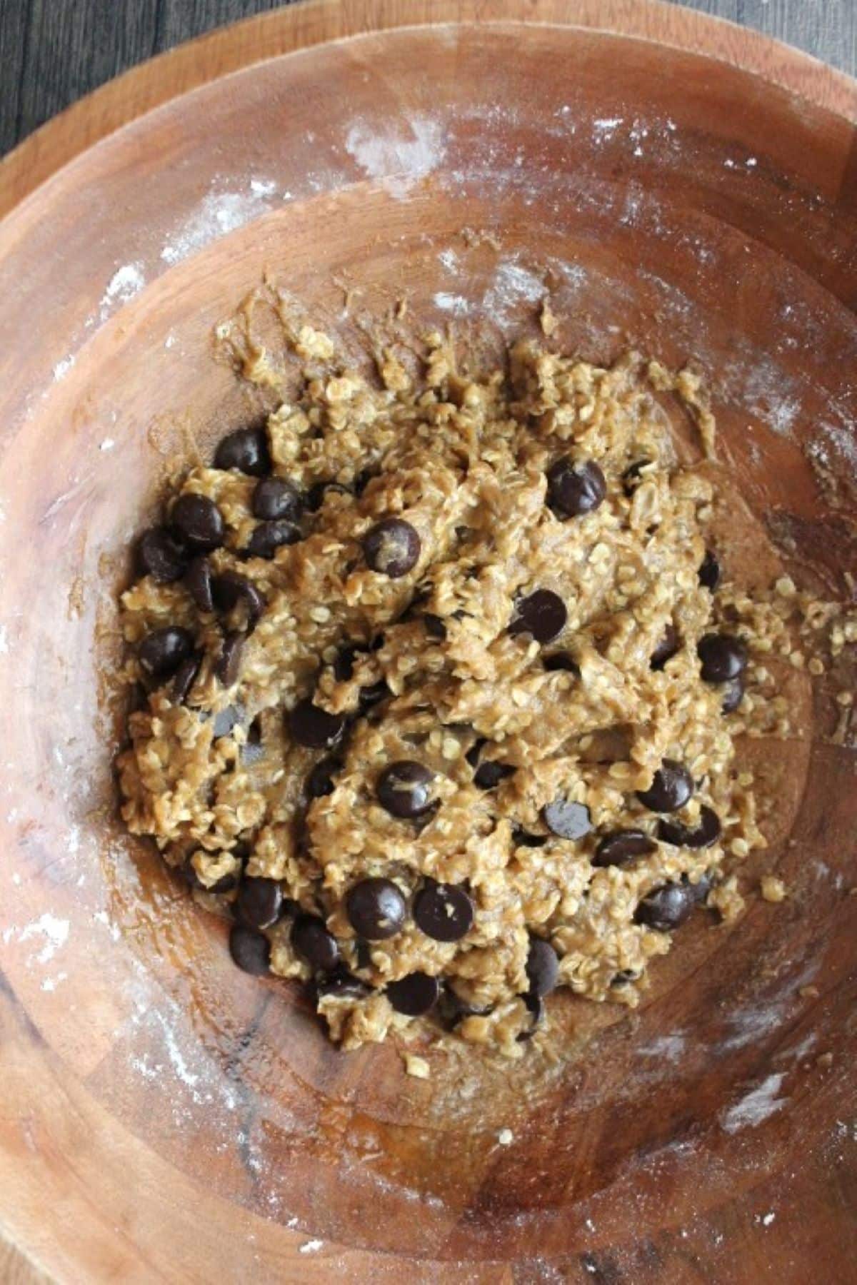 Image of pumpkin oatmeal chocolate chip cookie raw dough mix in a bowl.